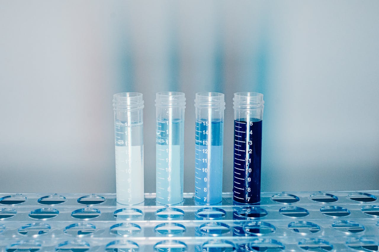 Close-up of test tubes filled with colorful liquids in a laboratory setting.